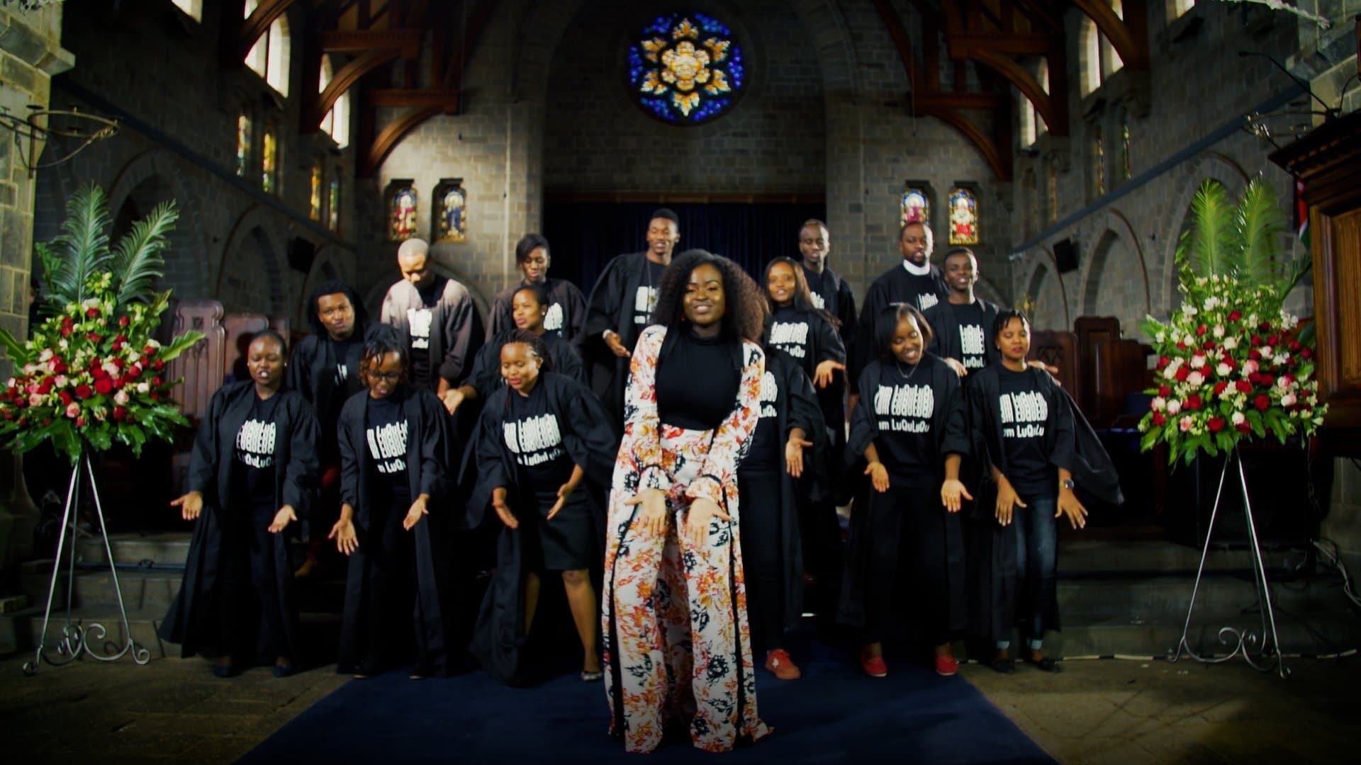 Mercy Masika with a choir in a sanctuary